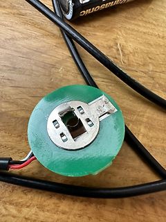 Grüner Stecker mit Metallkontakten und Kabeln