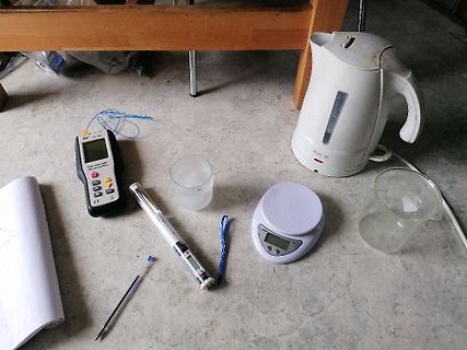Messgeräte, Wasserkocher und Laborutensilien auf Boden