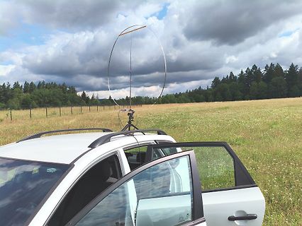 Antenne auf Stativ vor einem Auto im Feld