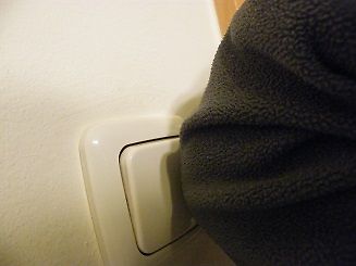 Hand drückt Lichtschalter