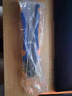 Werkzeug in Plastikverpackung auf Holzuntergrund