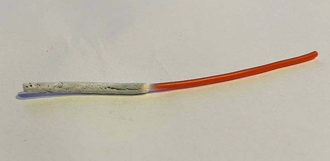 Grau beschichteter Draht oder Stab mit orangefarbenem Ende