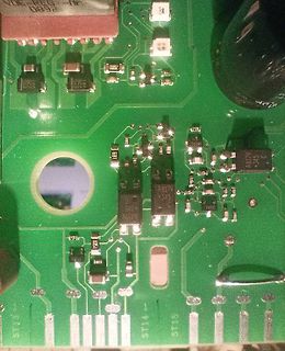 Nahaufnahme einer grünen Leiterplatte mit elektronischen Bauteilen