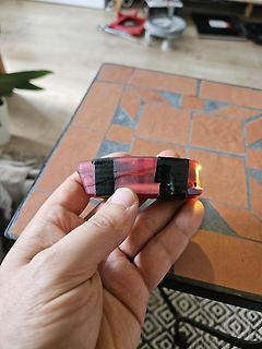 Hand hält ein kleines rotes Gehäuse mit Leuchteffekt
