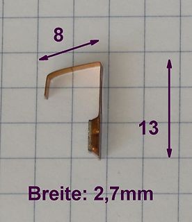 Kleines Metallbauteil mit Maßangaben auf Millimeterpapier