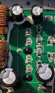 Nahaufnahme einer Leiterplatte mit Elektrolytkondensatoren und Spulen