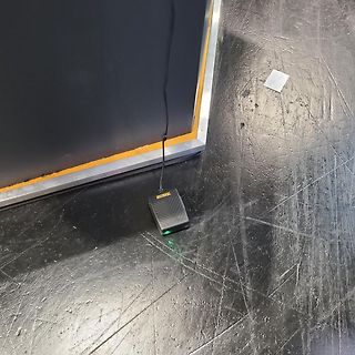 Black power supply unit on floor