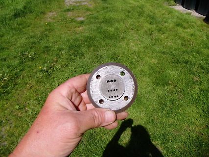 Metallflansch mit Lochmuster in der Hand gehalten