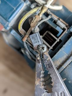 Werkstattaufnahme einer Reparatur mit Zange und Kabeln