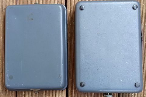 Zwei graue Metallgehäuse auf Holzuntergrund