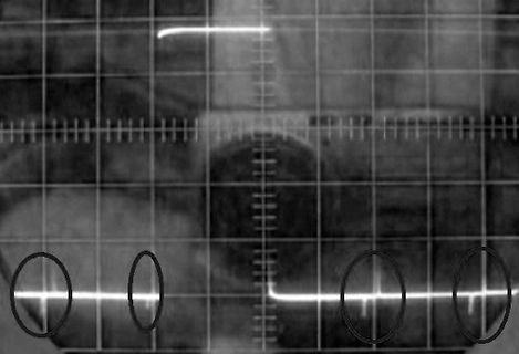 Abfotografierter Oszilloskop-Bildschirm mit Signalverlauf