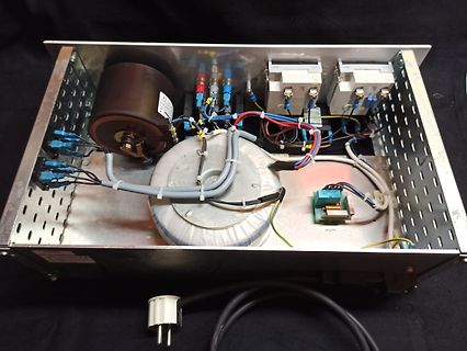 Innenansicht eines Netzteils mit Transformator und Kondensatoren