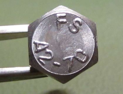 Nahaufnahme einer metallischen Sechskantmutter mit Prägung