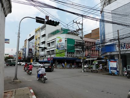 Straßenszene mit Gebäuden, Ampel und Motorrollern