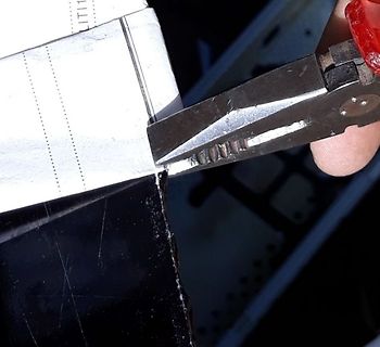 Nahaufnahme einer Zange und eines weißen Objekts