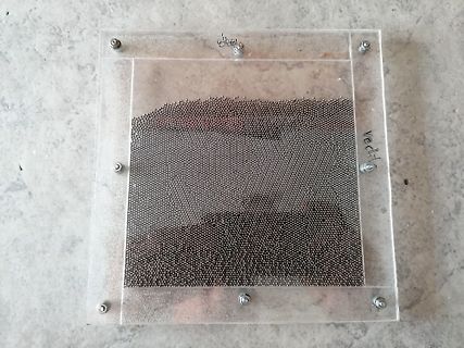 Metallkugeln in einem Acrylglasrahmen