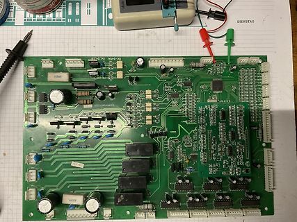 Grüne Leiterplatte mit elektronischen Bauteilen und Messspitzen