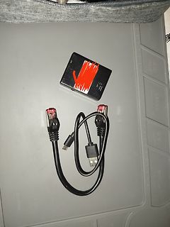 USB-Kabel und schwarzes Gehäuse auf Unterlage