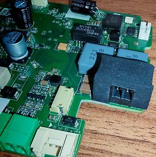 Nahaufnahme einer grünen Leiterplatte mit elektronischen Bauteilen