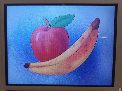 Abfotografierter Bildschirm mit Illustration von Apfel und Banane