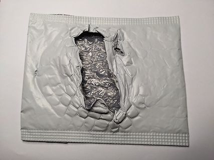 Aufgerissene Luftpolsterfolie in einer silbernen Verpackung