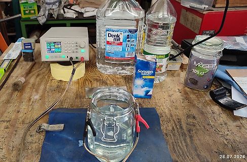Laboraufbau mit Netzgerät und Wasserbehältern