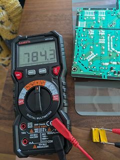 Digitalmultimeter und Leiterplatte auf Tisch