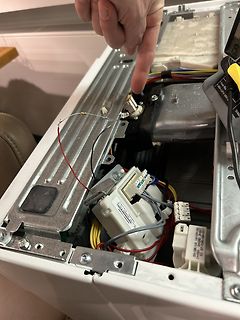 Innenansicht eines Elektrogeräts mit Verkabelung und Multimeter