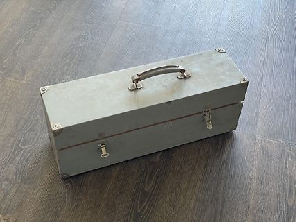 Graue Metallkiste auf Holzboden