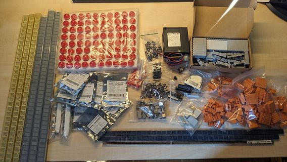 Verschiedene Elektronikbauteile und Kleinteile in Beuteln und Kartons