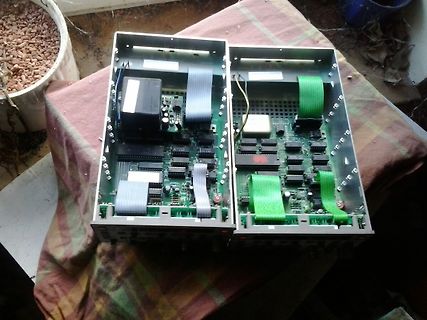 Zwei offene Elektronikgehäuse mit Leiterplatten und Flachbandkabeln