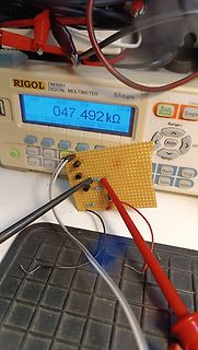 Digitalmultimeter misst Widerstand auf Lochrasterplatine