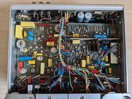 Innenansicht eines alten elektronischen Geräts mit vielen Bauteilen