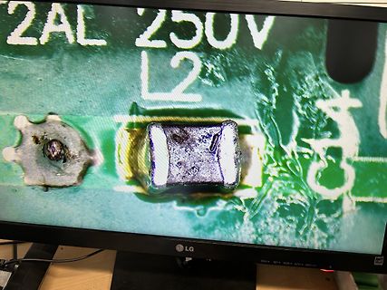 Foto eines Monitors mit mikroskopischer Aufnahme einer Leiterplatte