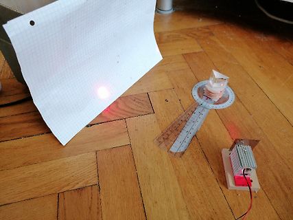 Optischer Aufbau mit Laser, Prisma und Lineal