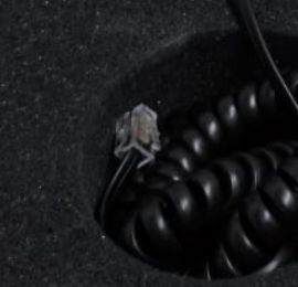 Spiralkabel und Stecker in einer Aussparung