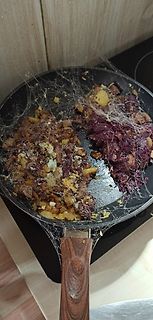 Essen in einer Pfanne mit Käsefäden