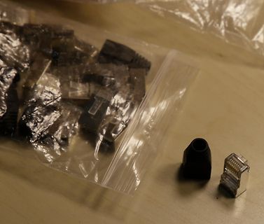 RJ45 Stecker in Plastiktüte und lose auf Tisch
