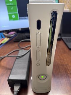 Xbox 360 Konsole und Netzteil auf Holztisch