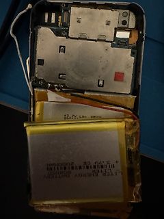 Offenes Smartphone mit sichtbarem Akku und Innenleben
