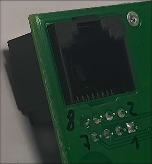 Nahaufnahme einer Leiterplatte mit RJ45-Buchse und Beschriftung