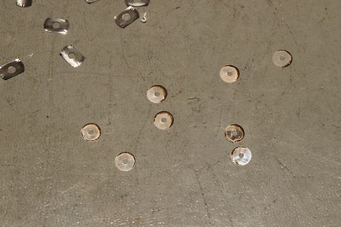 Metallische Scheiben mit Loch auf Untergrund