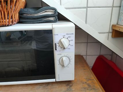 Weiße Mikrowelle auf Holzoberfläche