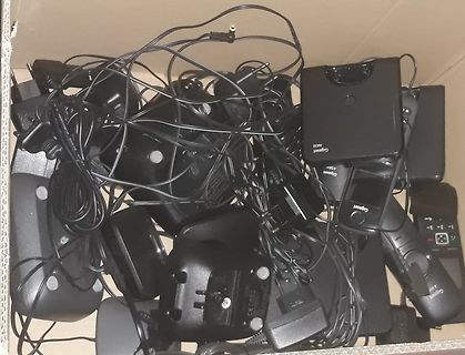 Haufen von Gigaset Telefonen und Netzteilen