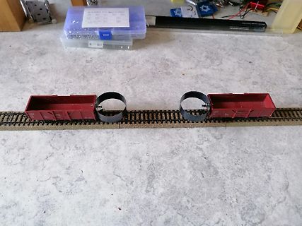 Modellbahngleis mit zwei roten Güterwagen