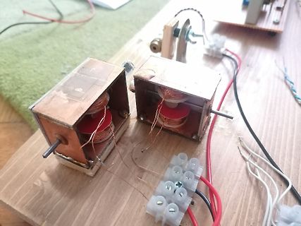 Aufbau mit zwei Spulen und Klemmen auf Holzbrett