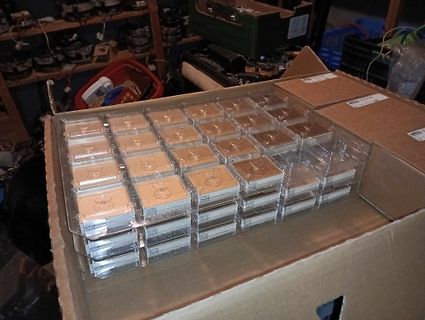 Karton mit kleinen Kunststoffboxen in einer Werkstatt