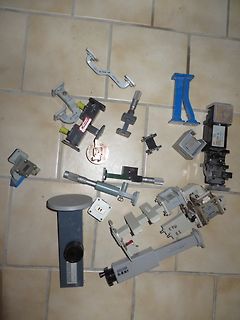 Verschiedene mechanische Bauteile und Halterungen auf Fliesenboden