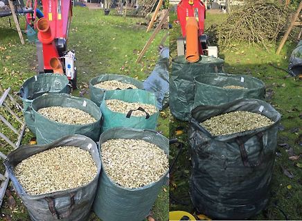 Große Säcke mit Gartenabfällen vor Häcksler