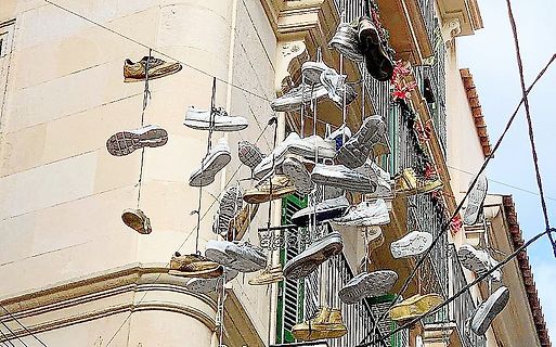 An Schnüren hängende Schuhe vor einem Gebäude